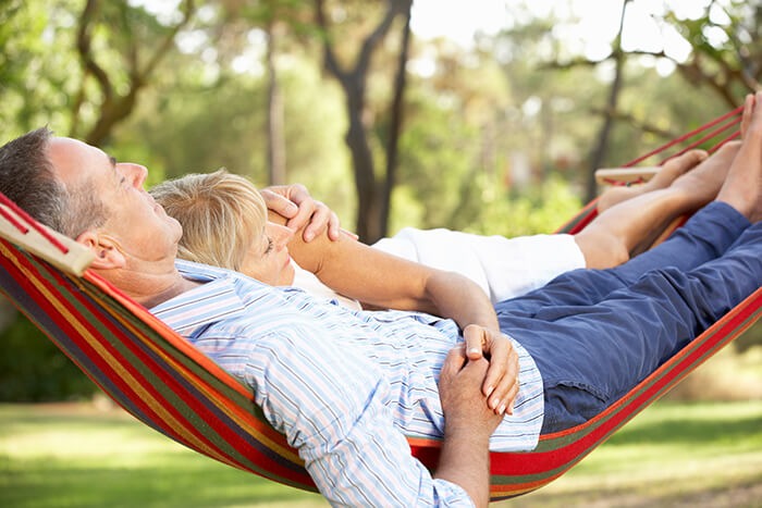 Couple relaxing on a hammock.