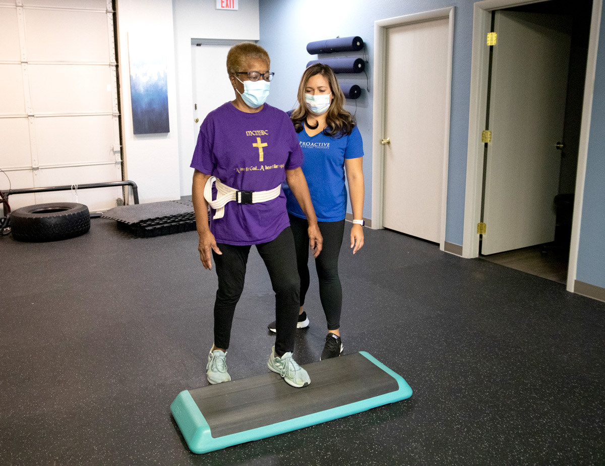 Patient doing step exercises in front of their therapist.