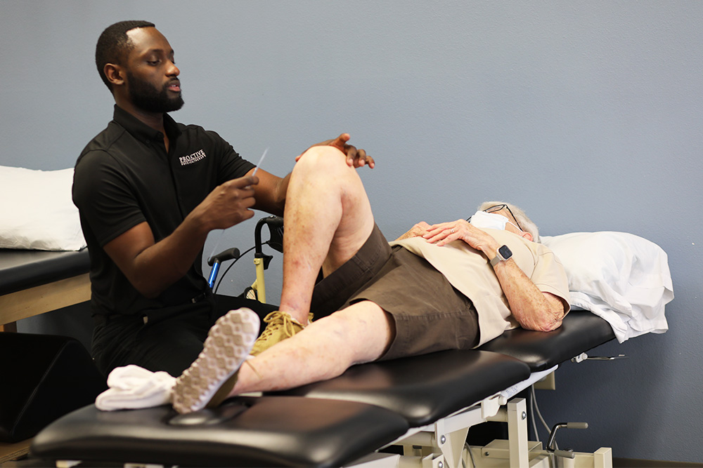 Physical Therapist measures patients ROM of the knee.