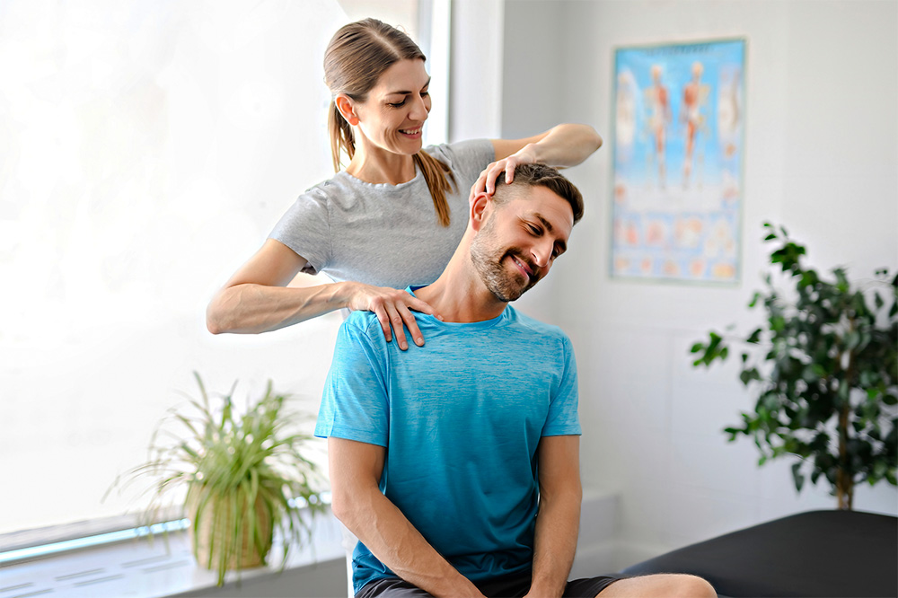 Phsycial therapist helping patient with neck pain.