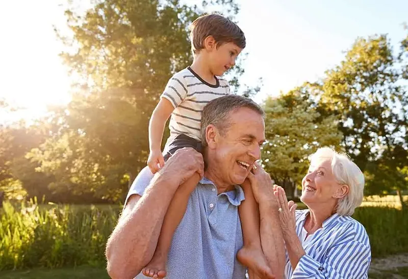 Grandfather with child on his shoulders.