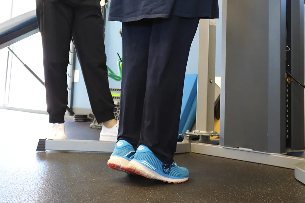Patient performing leg raises exercise.