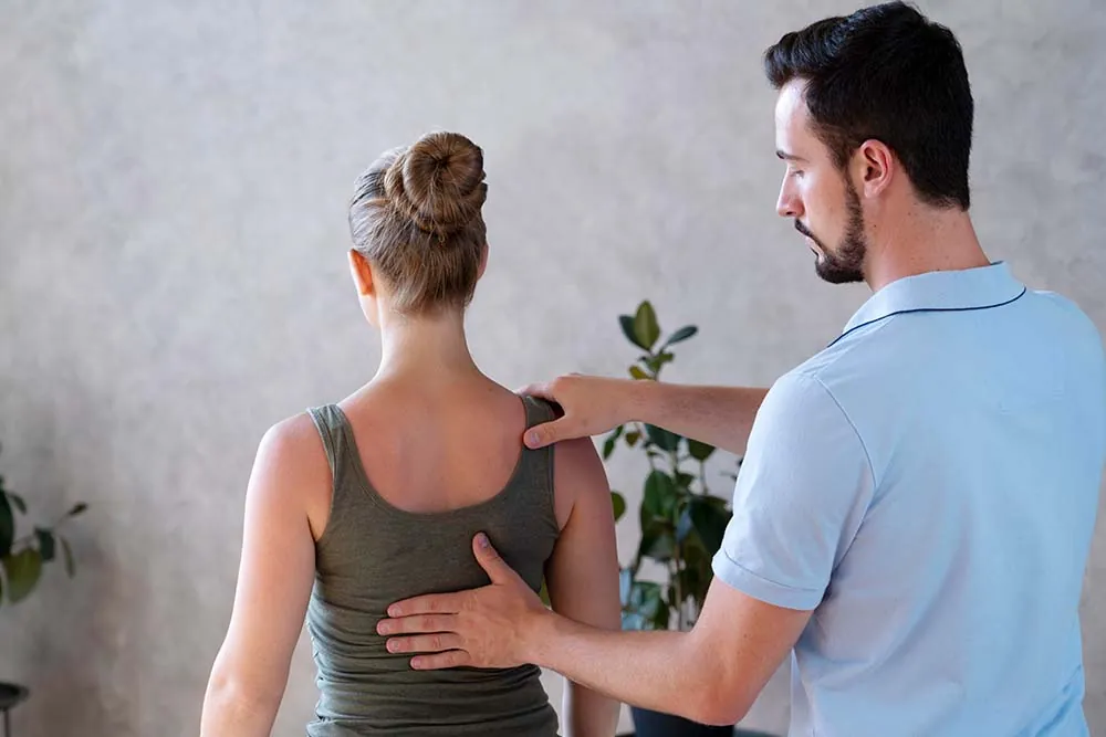Physical therapist treating patient for back pain.