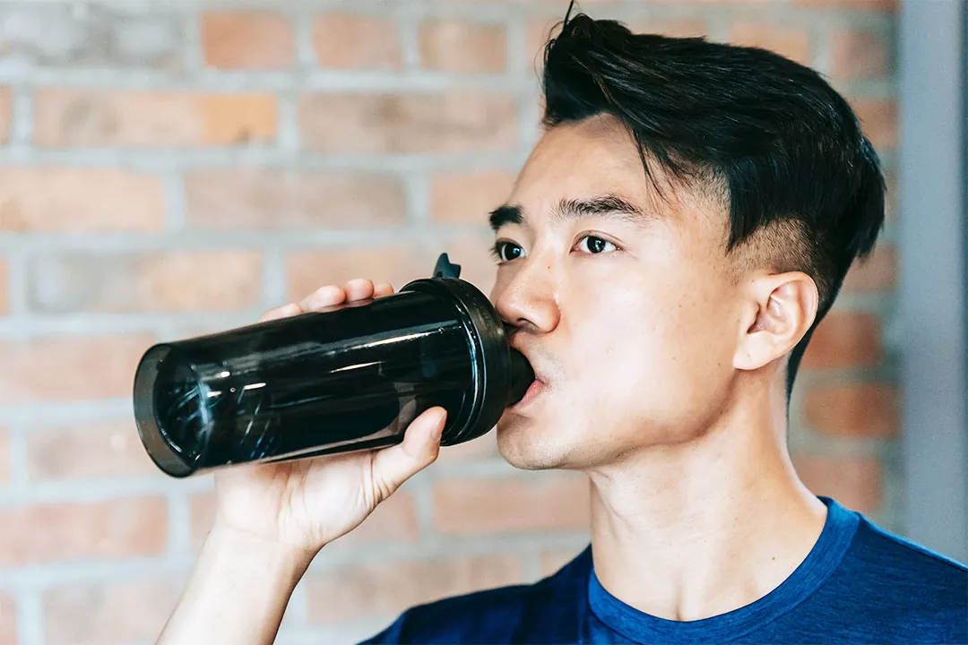 Man drinking water from bottle.