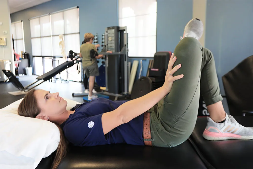 PT, Sarah performing stretch for sciatica pain relief.