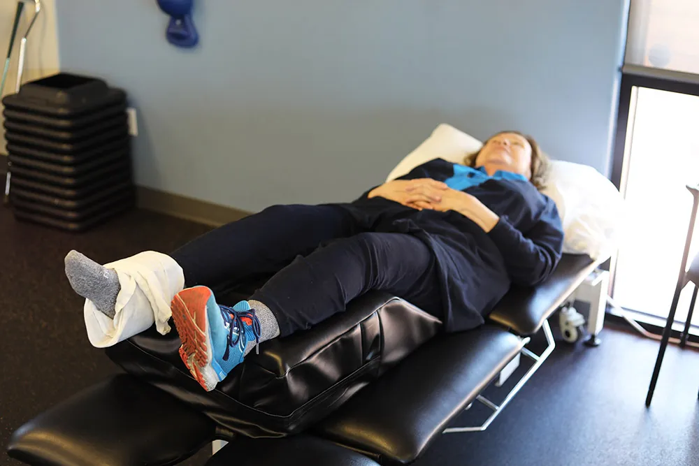 Patient relaxing with ice treatment on her foot.