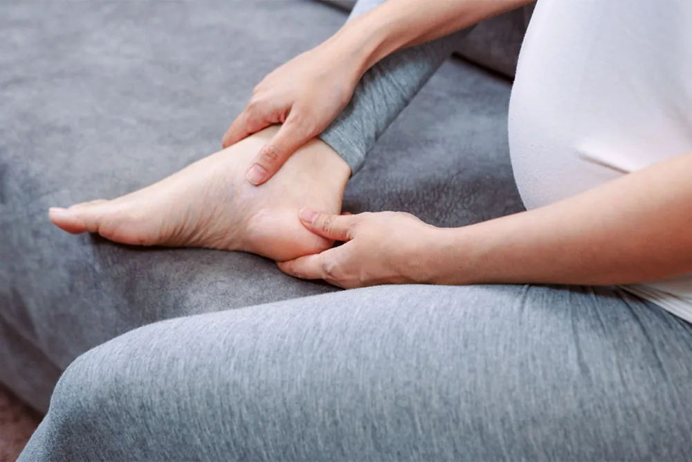 Pregnant woman suffering from foot pain.