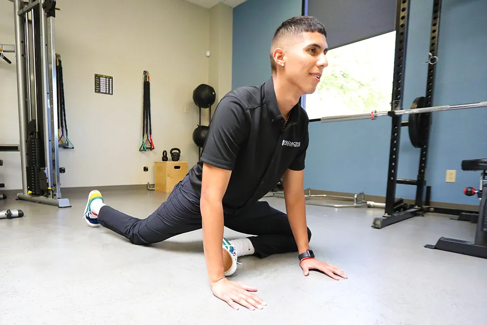 Tech demonstrating pigeon stretch form.