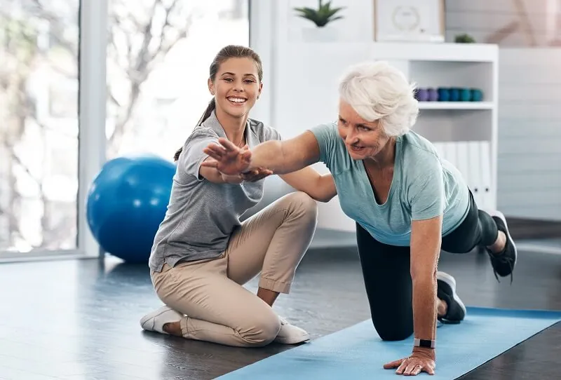 Senior woman being treated by a physiotherapist for balance issues.