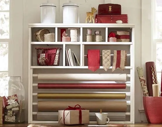 Gift wrapping table with paper, ribbon and tape.
