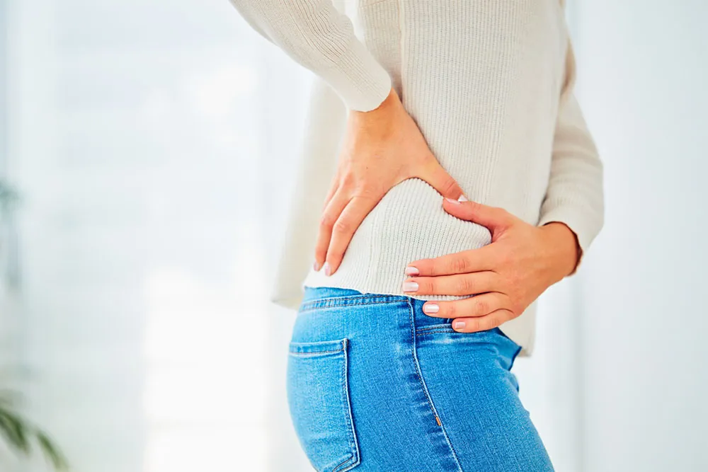 Women suffering hip pain while walking.