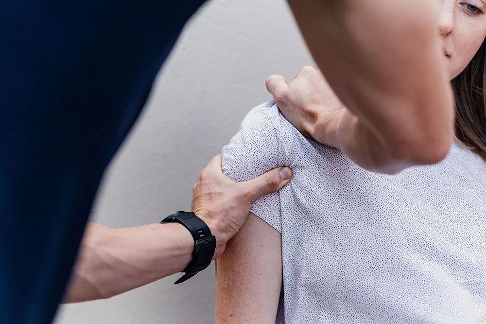 PT assesing shoulder for Hypermobility Syndrome.